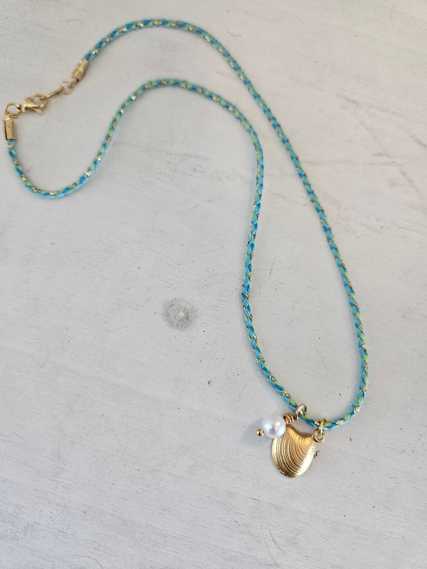 Gold Seashell on aqua cord